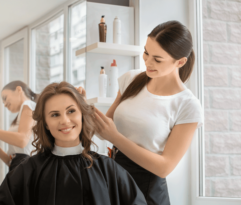 Stylist working on client's hair in a salon.